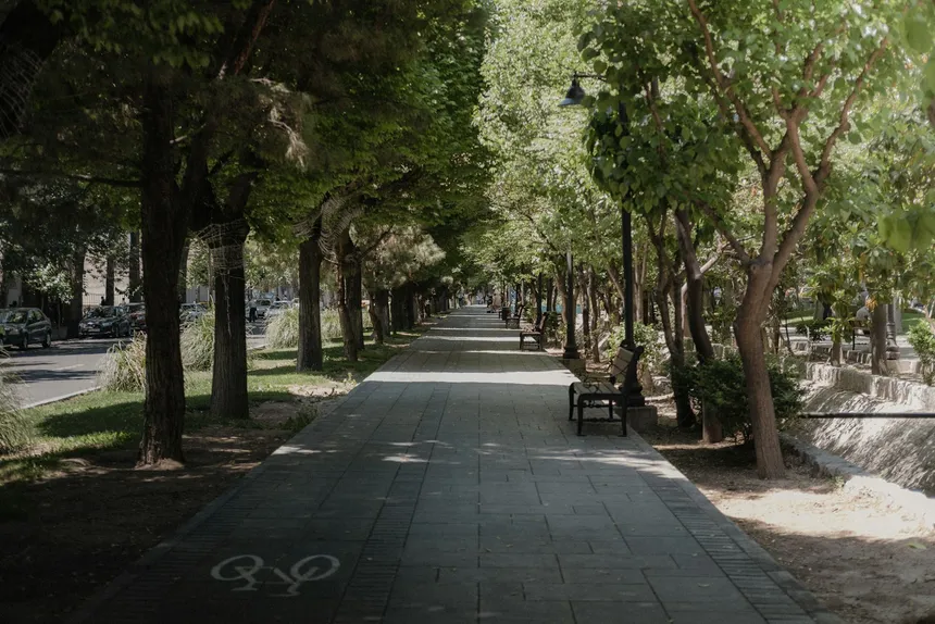 A long empty paved path running away between verges, the kind of ride a range claim is imagined on