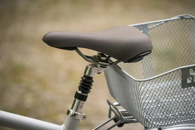 A saddle and rear basket on an upright trike, where most of the carried load ends up sitting