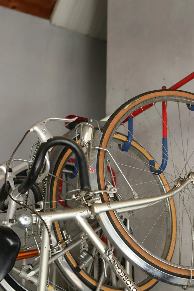 A wall-mounted bicycle rack holding a machine clear of the floor, the storage method a trike cannot use