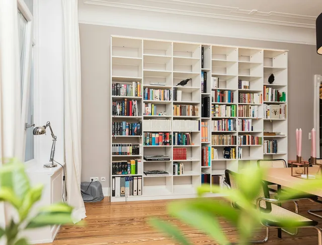 Tall white shelving running to the ceiling, the storage most childproofing advice recommends