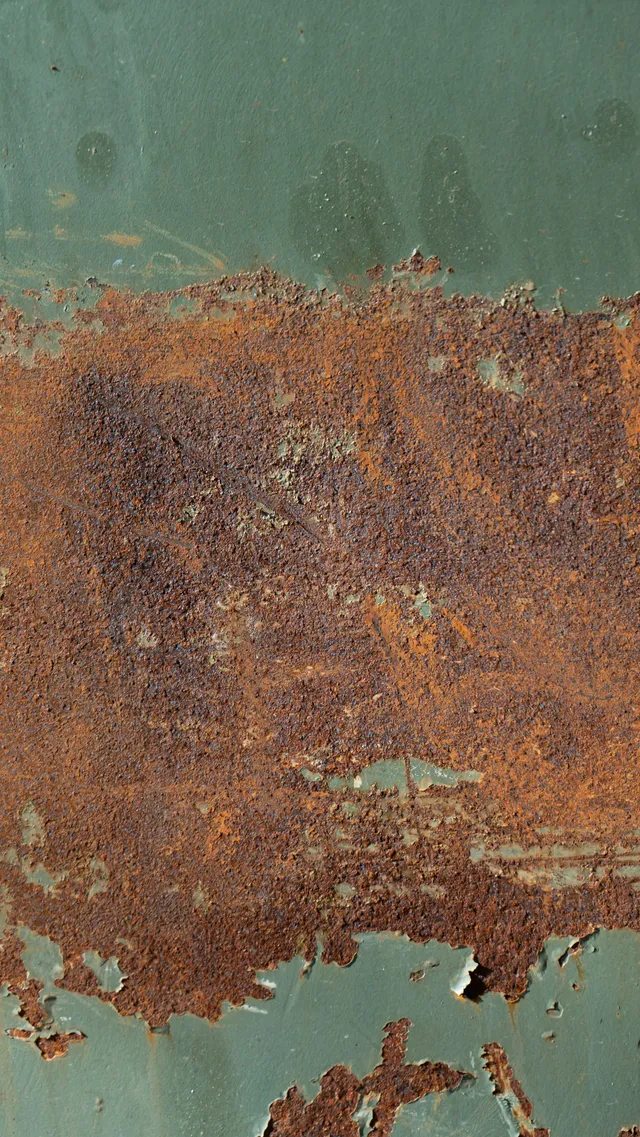 A rusted metal surface, the ordinary outcome for bare steel in an unheated timber building