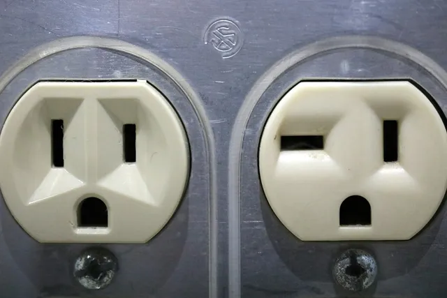 Two mains outlets side by side in a metal wall plate, the one thing this setup does not need